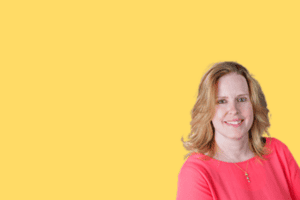 Professional headshot of Christi Mecillas wearing a coral blouse.