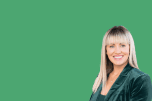 Professional headshot of Emilee Cronin wearing a dark green blazer.